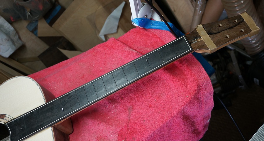 Preheated fingerboard located in place with 3 pins.jpg