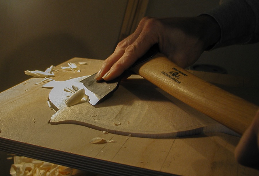 Rougfing out mandolin top with carving axe.jpg